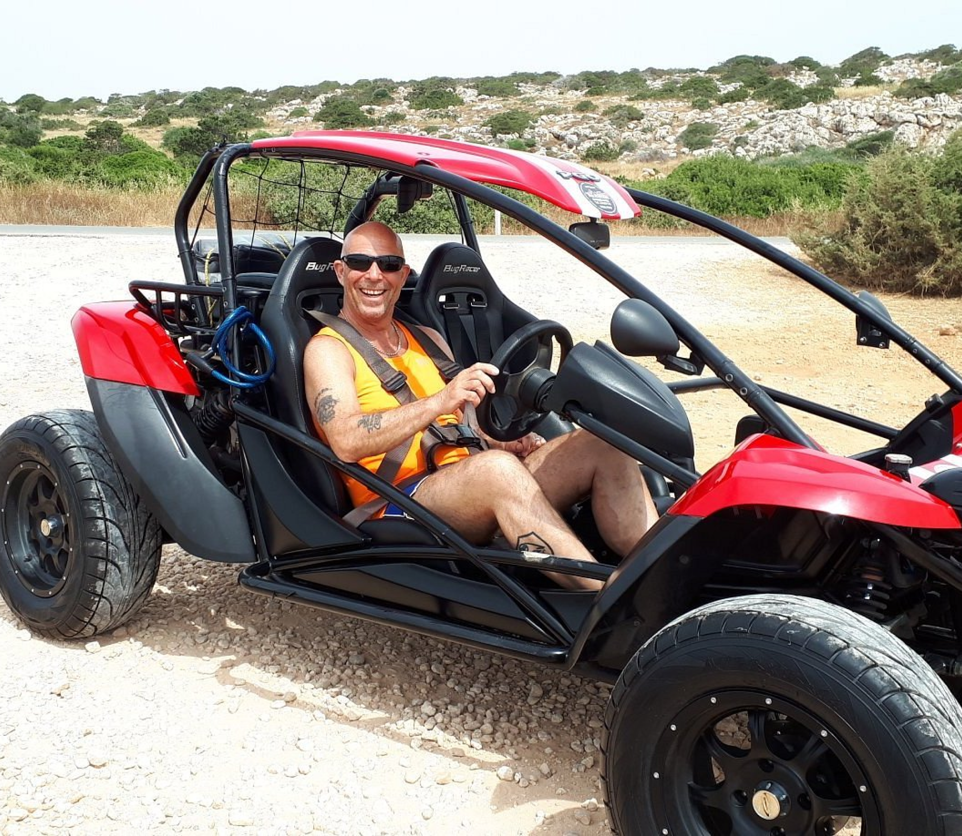 a man riding a buggy in the dessert